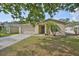 Cozy single-story home with a two-car garage, neatly trimmed lawn, and a well-maintained exterior at 13750 Fareham Rd, Odessa, FL 33556