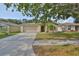 Charming single-story home with a manicured lawn, an attached two-car garage, and a neatly landscaped front yard at 13750 Fareham Rd, Odessa, FL 33556
