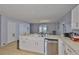 Bright kitchen offers white cabinetry and stainless steel appliances with views into dining area and pool at 13750 Fareham Rd, Odessa, FL 33556