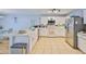 Spacious kitchen and dining area with white cabinetry, stainless steel appliances, and tile flooring at 13750 Fareham Rd, Odessa, FL 33556