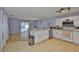 Open-concept kitchen and dining room with stainless steel appliances and sliding glass doors to the pool at 13750 Fareham Rd, Odessa, FL 33556