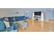 Bright living room featuring wood floors, a modern couch and a TV stand at 13750 Fareham Rd, Odessa, FL 33556