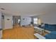 Bright living room featuring wood floors, a modern couch and a dog bed at 13750 Fareham Rd, Odessa, FL 33556