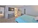 Spacious main bedroom with a tv, ensuite bathroom, and comfortable bed at 13750 Fareham Rd, Odessa, FL 33556