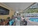 Entertain in this outdoor kitchen and dining area adjacent to the sparkling pool at 13750 Fareham Rd, Odessa, FL 33556
