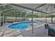Beautiful pool with screened enclosure and lounge seating, providing the perfect outdoor retreat at 13750 Fareham Rd, Odessa, FL 33556