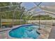 Lounge in this stunning screened-in pool with sun umbrella and lounge seating at 13750 Fareham Rd, Odessa, FL 33556