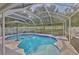 Inviting screened-in pool area with lounge chairs and umbrella, perfect for relaxation at 13750 Fareham Rd, Odessa, FL 33556