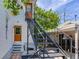 Exterior view of a white house featuring a metal staircase leading to an upper-level entrance at 1423 Dr Martin Luther King Jr N St, St Petersburg, FL 33704