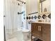 Well-maintained bathroom with decorative tile accents, a shower-tub combo, and updated fixtures at 1423 Dr Martin Luther King Jr N St, St Petersburg, FL 33704