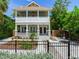 Beautiful two-story home boasts a welcoming porch, detailed columns, and fresh landscaping at 1423 Dr Martin Luther King Jr N St, St Petersburg, FL 33704