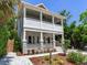 Inviting two-story home featuring a charming porch, classic design, and lush landscaping at 1423 Dr Martin Luther King Jr N St, St Petersburg, FL 33704