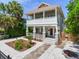 Charming two-story home featuring a welcoming front porch and walkway at 1423 Dr Martin Luther King Jr N St, St Petersburg, FL 33704