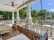 Relaxing front porch with a swing and comfortable seating area at 1423 Dr Martin Luther King Jr N St, St Petersburg, FL 33704