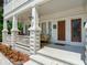 Inviting front porch features a swing, sitting area, and detailed stonework at 1423 Dr Martin Luther King Jr N St, St Petersburg, FL 33704