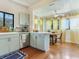 The updated kitchen offers stainless appliances, light green cabinets, and a dining area at 1423 Dr Martin Luther King Jr N St, St Petersburg, FL 33704