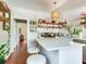 Open kitchen featuring an island with seating, custom shelves, and stainless steel appliances at 1423 Dr Martin Luther King Jr N St, St Petersburg, FL 33704