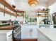 Bright kitchen area with a stainless steel oven, cooktop, and convenient open shelving at 1423 Dr Martin Luther King Jr N St, St Petersburg, FL 33704