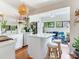 Bright kitchen with an island, pendant lighting, wood shelves, and hardwood floors at 1423 Dr Martin Luther King Jr N St, St Petersburg, FL 33704