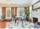 Cozy living room with a fireplace, hardwood floors, and lots of natural light at 1423 Dr Martin Luther King Jr N St, St Petersburg, FL 33704