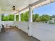 Spacious porch featuring comfortable chairs and a small table, perfect for relaxing and enjoying the view at 1423 Dr Martin Luther King Jr N St, St Petersburg, FL 33704