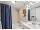 Cozy bathroom featuring a shower-tub combination, a sink with a white vanity and bright lighting at 14401 Gulf Blvd # 106, Madeira Beach, FL 33708