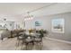 Dining area featuring a modern light fixture and views into the living room at 14401 Gulf Blvd # 106, Madeira Beach, FL 33708