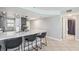 Kitchen with an island with seating and views into the hallway and doorways at 14401 Gulf Blvd # 106, Madeira Beach, FL 33708