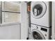 Functional laundry area featuring a stackable washer and dryer unit with window at 14401 Gulf Blvd # 106, Madeira Beach, FL 33708