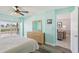 Light-filled bedroom with ocean views, patio access, and hardwood flooring at 14401 Gulf Blvd # 106, Madeira Beach, FL 33708
