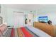 Comfortable bedroom with a closet, bureau with TV, and beach themed decorations at 14401 Gulf Blvd # 106, Madeira Beach, FL 33708