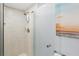 Modern shower stall with tile surround, rainfall shower head, and frameless glass door at 14401 Gulf Blvd # 106, Madeira Beach, FL 33708