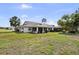 Lush backyard with mature landscaping, featuring a comfortable screened lanai at 1633 Bentwood Dr, Sun City Center, FL 33573