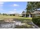 Expansive backyard with verdant lawn and a view of neighboring properties at 1633 Bentwood Dr, Sun City Center, FL 33573