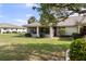 Well-manicured backyard with lanai offers a serene outdoor living space at 1633 Bentwood Dr, Sun City Center, FL 33573