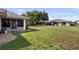 Spacious backyard featuring a well-maintained lawn and a screened lanai at 1633 Bentwood Dr, Sun City Center, FL 33573
