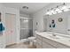 Bright bathroom featuring a shower, ample lighting, and a vanity, offering a clean and functional space at 1633 Bentwood Dr, Sun City Center, FL 33573