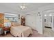 Bright bedroom features a cozy bed, ample natural light, and closet storage at 1633 Bentwood Dr, Sun City Center, FL 33573