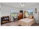 Inviting bedroom featuring a chair, TV, built-in shelving and storage, offering a relaxing and functional living space at 1633 Bentwood Dr, Sun City Center, FL 33573