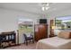 Comfortable bedroom with a chair, TV, built-in shelving and storage, offering a relaxing and functional living space at 1633 Bentwood Dr, Sun City Center, FL 33573