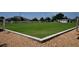 Beautifully maintained lawn bowling green with a concrete border in a retirement community at 1633 Bentwood Dr, Sun City Center, FL 33573