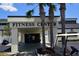Exterior of the community fitness center with palm trees and golf cart parking at 1633 Bentwood Dr, Sun City Center, FL 33573