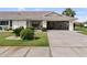 Inviting home featuring a neat driveway, a golf cart, and landscaped surroundings at 1633 Bentwood Dr, Sun City Center, FL 33573