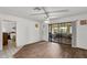 Open living space with sliding glass doors to patio with plenty of light and hardwood flooring at 1633 Bentwood Dr, Sun City Center, FL 33573