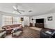 Inviting living room featuring hardwood floors, a ceiling fan, and ample space for relaxation and entertainment at 1633 Bentwood Dr, Sun City Center, FL 33573