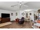 Bright and airy living area features hardwood floors, a ceiling fan, and views into the dining area at 1633 Bentwood Dr, Sun City Center, FL 33573
