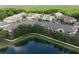 Aerial view of the condo community featuring lake views, lush landscaping, and well-maintained exteriors at 16431 Enclave Village Dr # 16431, Tampa, FL 33647