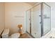 Bathroom featuring a tile floor, toilet, and shower with glass doors at 16431 Enclave Village Dr # 16431, Tampa, FL 33647