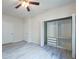 Bedroom featuring hardwood-style flooring, a ceiling fan, and a closet with an organizer at 16431 Enclave Village Dr # 16431, Tampa, FL 33647