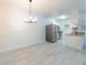 Open dining room with hardwood-style floors that flows into the kitchen with granite countertops and stainless steel appliances at 16431 Enclave Village Dr # 16431, Tampa, FL 33647